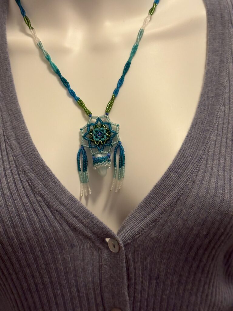 Glass Seed Bead Shield Style Necklace 2 Blue lace on blue sweater