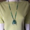 Blue lace necklace on green tee