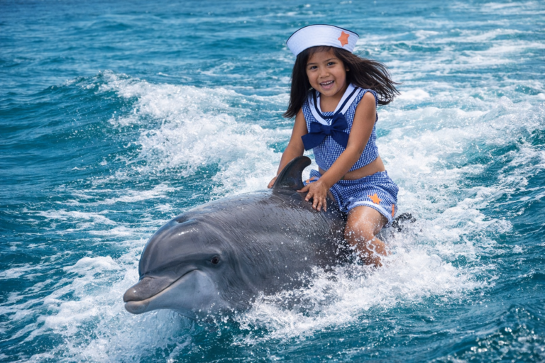 0bbf4db3 4e2e 47a1 94fd faaf55ee5f38Val on a dolphin riding the waves