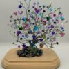 Colorful and Sparkly Wire Tree on a wooded base. Made with silver wire and multiple beads, rocks and peacock focal piece.