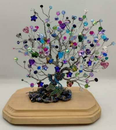 Colorful and Sparkly Wire Tree on a wooded base. Made with silver wire and multiple beads, rocks and peacock focal piece.