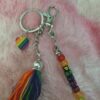 Custom Pride Keychain with rainbow letter beads spelling PROUD on a silver clasp.