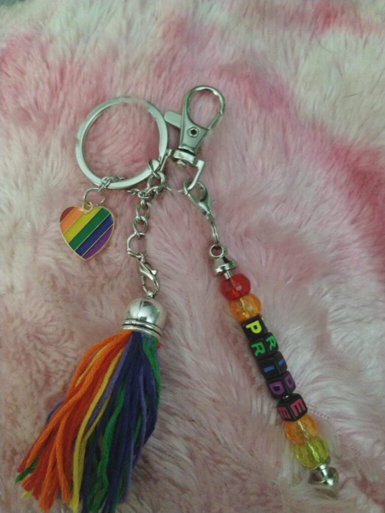 Custom Pride Keychain with rainbow letter beads spelling PROUD on a silver clasp.