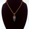 Photo of. Rooted Spirit Wire Wrapped Moss Agate Necklace on a neck form