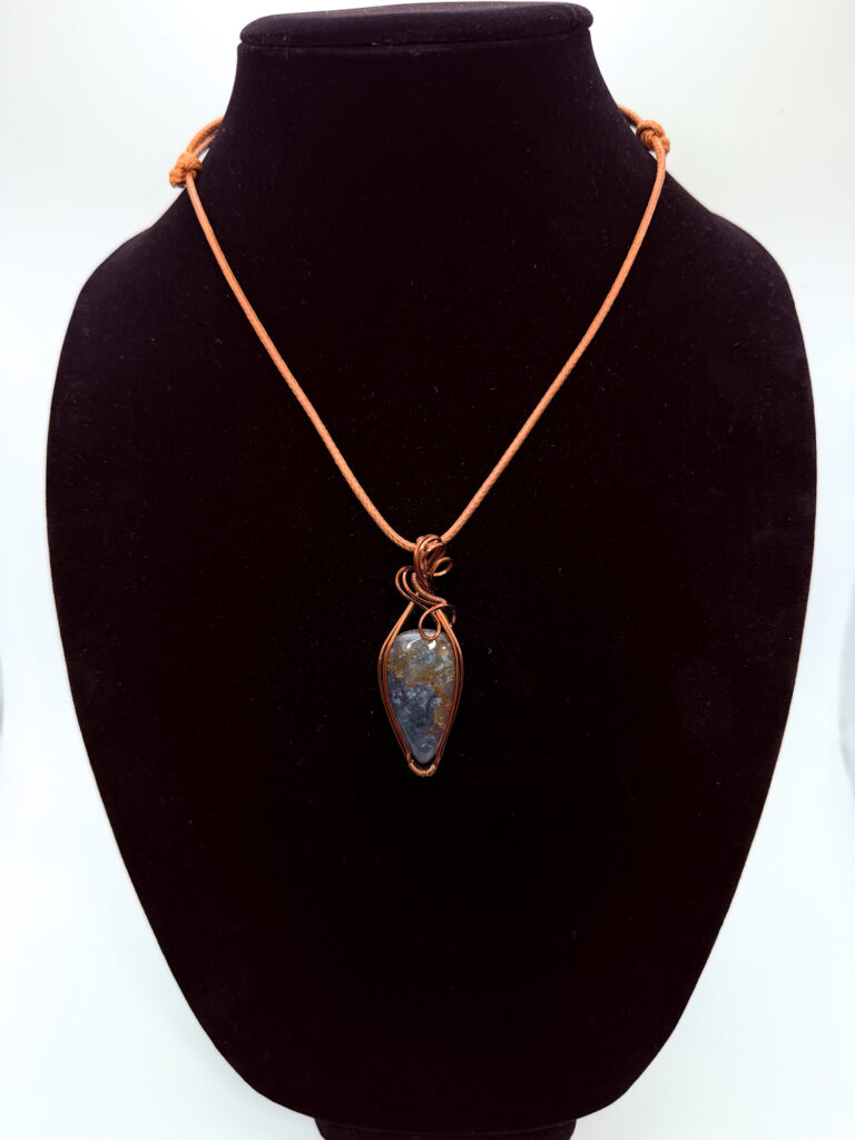 Photo of. Rooted Spirit Wire Wrapped Moss Agate Necklace on a neck form