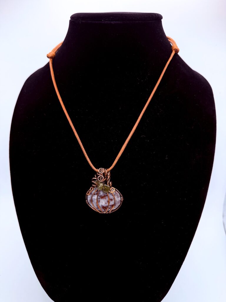 Grounding Magic Plume Agate Pumpkin Necklace 6 Photo of Grounding Magic Plume Agate Pumpkin Necklace on a neck form