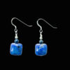 Deep blue square dumortierite earrings accented by a small lapis lazuli bead. The earrings feature Sterling Silver French ear wires
