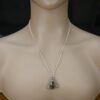 Pendant shown on a silver chain on a mannequin