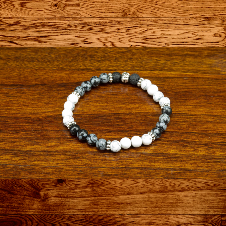 Snowflake Obsidian and Howlite Stretch Bracelet 2 Howlite and snowflake obsidian bead bracelet on a wood background