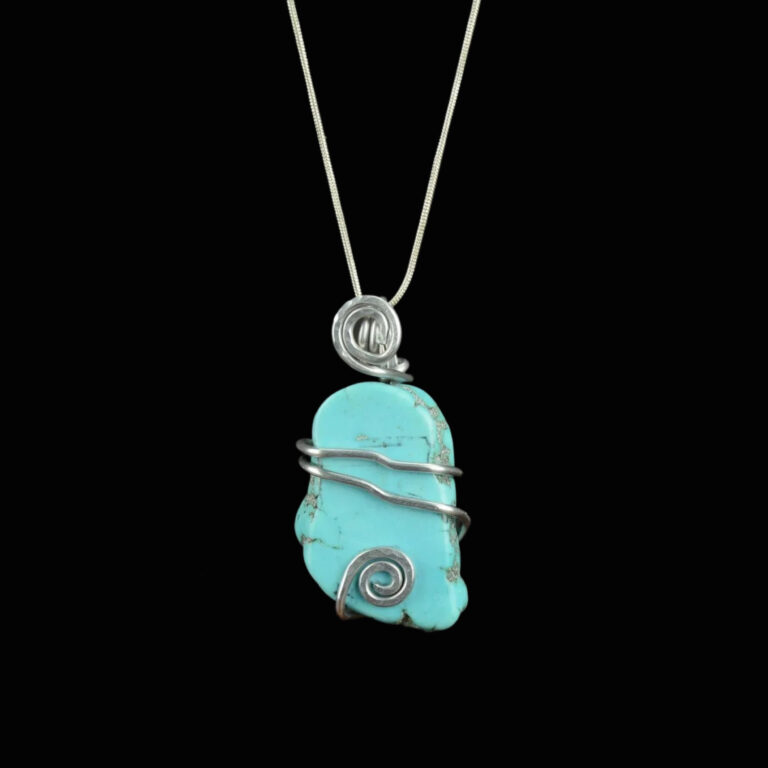 Turquoise Pendant 9 Turquoise pendant with a silver colored wrap with two strands of wire across the middle with slight bends in the wire and a silver swirl at the top in front of the bail and another silver swirl at the bottom of the pendant.