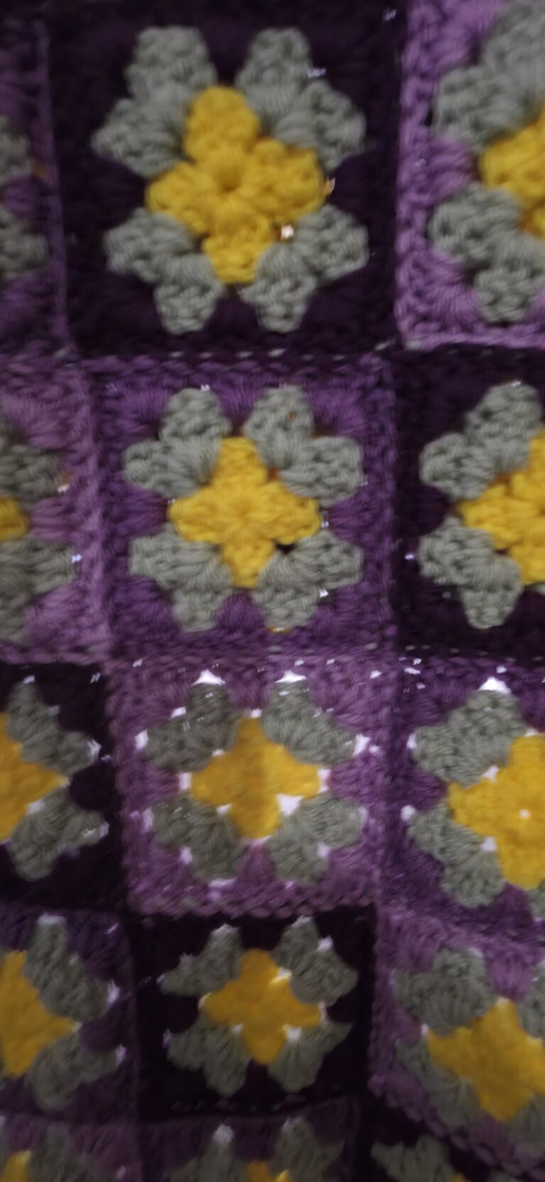 A lovingly handcrafted crochet baby lapghan blanket in enchanting shades of purple and green 3 purples crochet baby afghan closeup